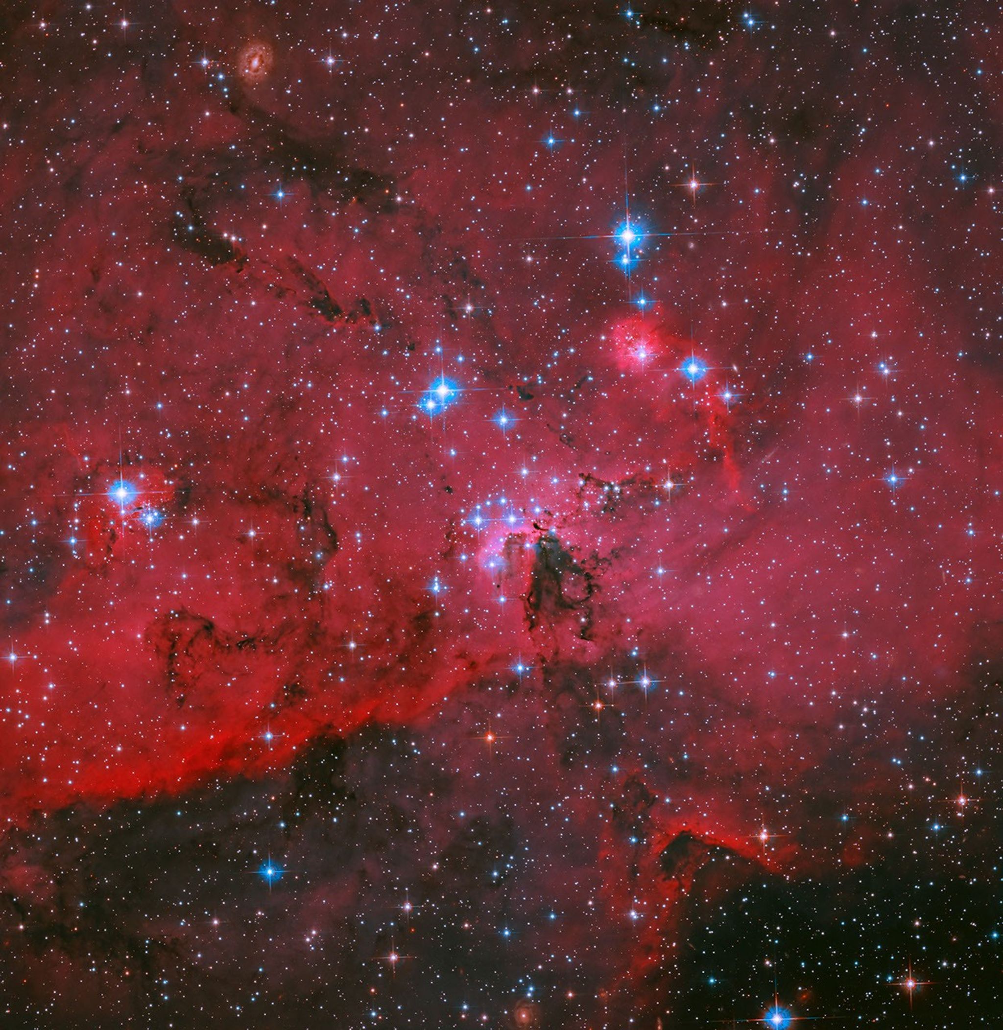 A nova tela do Hubble: um berçário de estrelas em carmesim