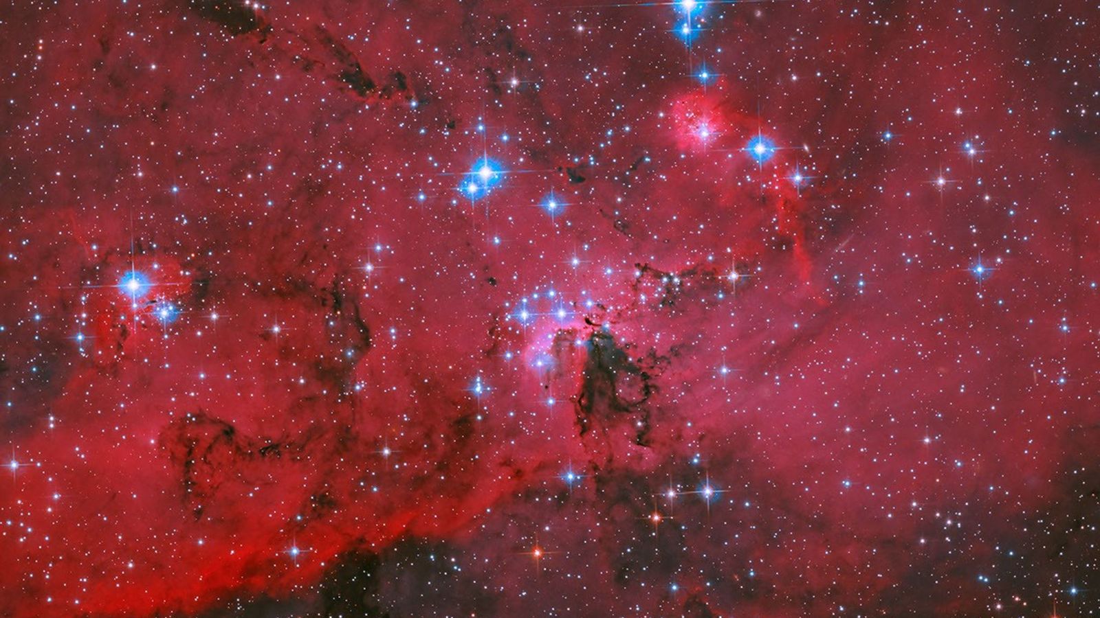 A nova tela do Hubble: um berçário de estrelas em carmesim