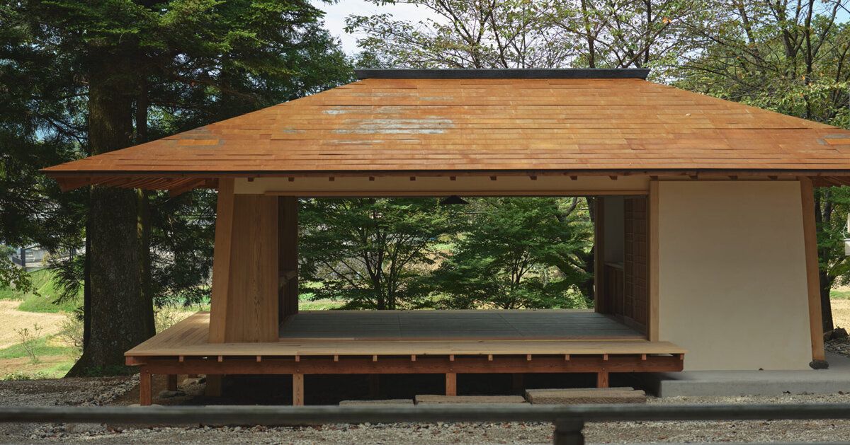 Escritório de santuário japonês usa madeira e pedra em vale montanhoso